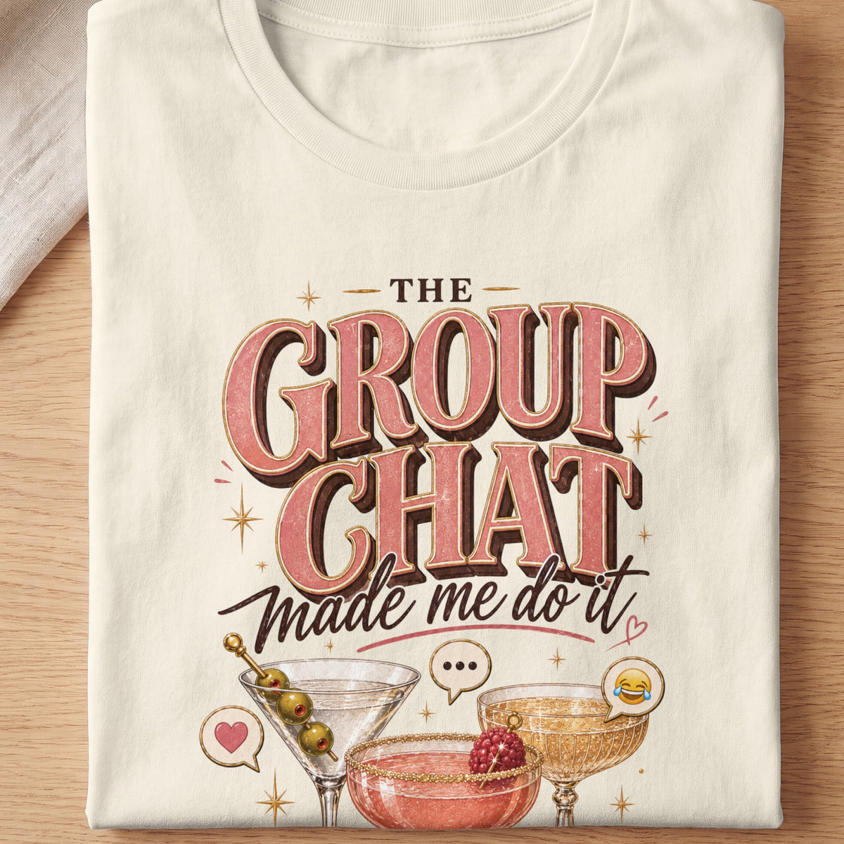 "The group chat made me do it" text with cocktails and emojis on a cream t-shirt.