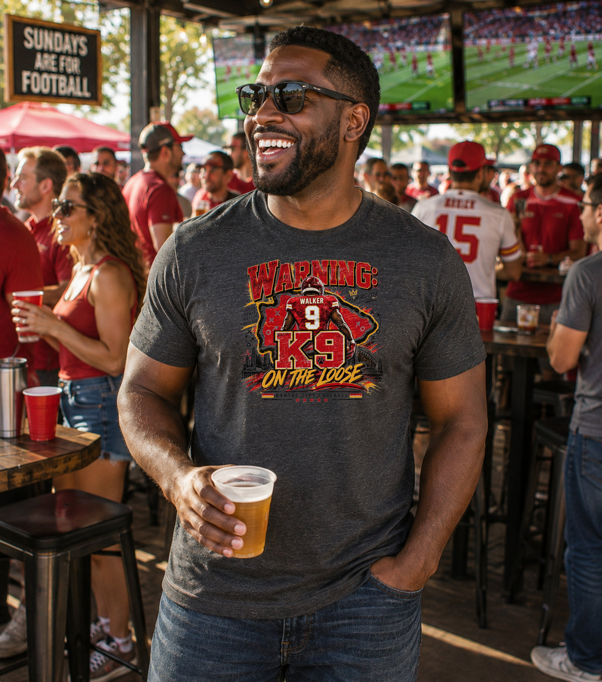 Man in dark t-shirt with "K9 On The Loose" graphic and beer.