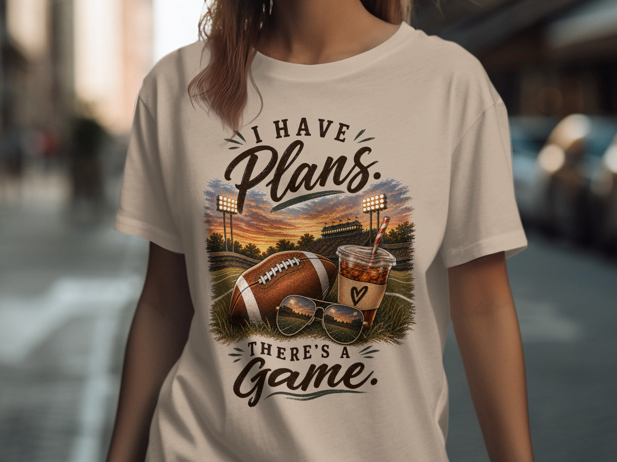 T-shirt with "I have Plans. There's a Game." text, football, drink, and sunglasses.