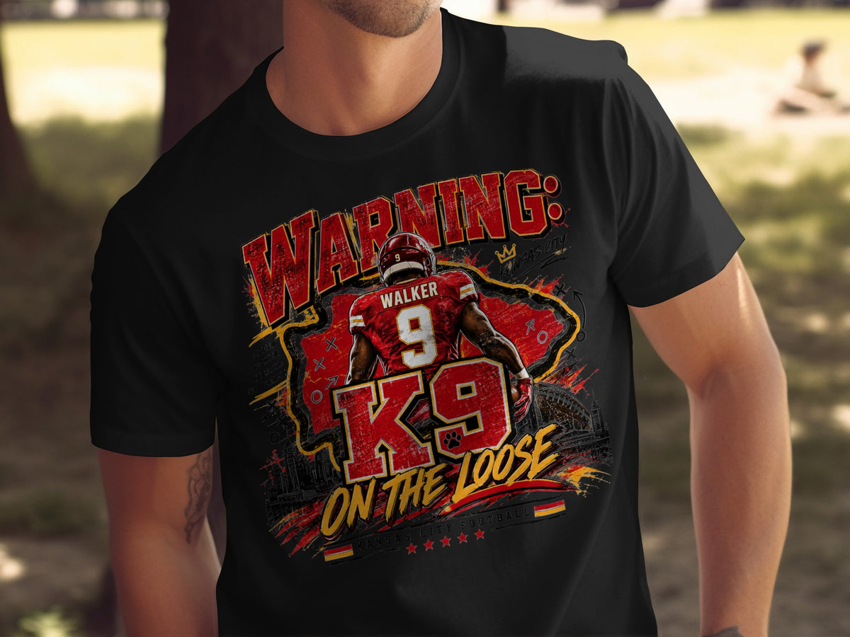 Black t-shirt graphic featuring "WARNING: K9 ON THE LOOSE" and a football player.