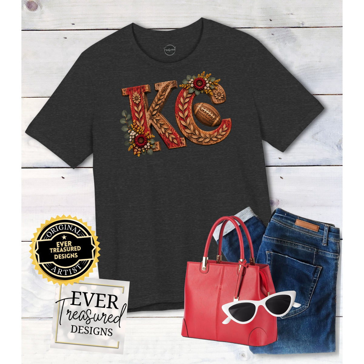 Dark gray t-shirt with "KC" and football design, red handbag, jeans, and white sunglasses.