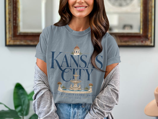 Gray t-shirt with "Kansas City" text, fountain, and building graphic.
