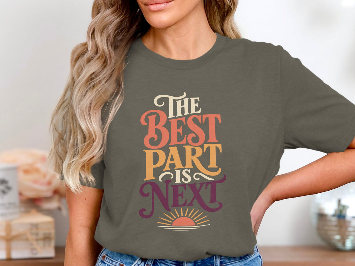 T-shirt with text "The Best Part Is Next" and a sunrise graphic.