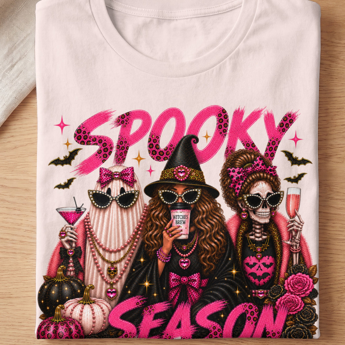Three Halloween characters, "Spooky Season" text on a t-shirt.
