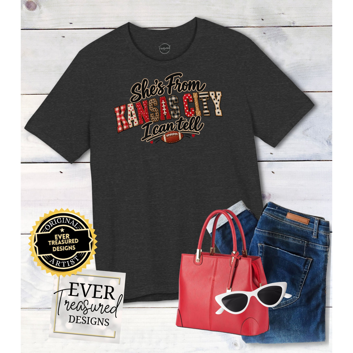 Dark t-shirt with "She's From Kansas City I Can Tell" graphic and football.