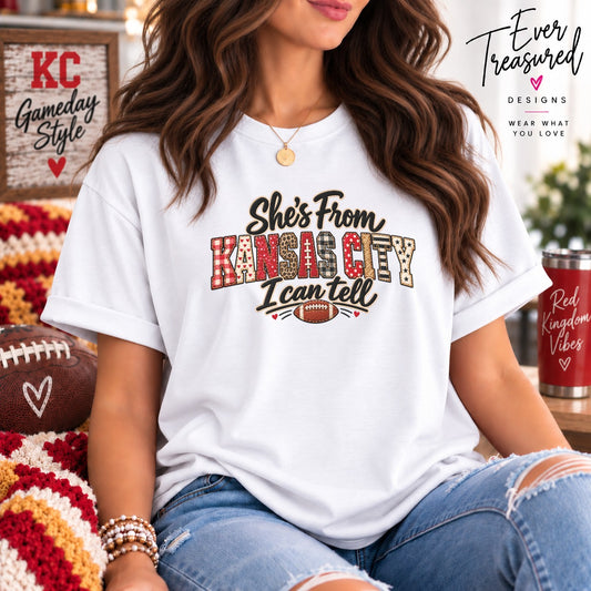 White t-shirt with "She's From KANSAS CITY I can tell" text and football graphic.