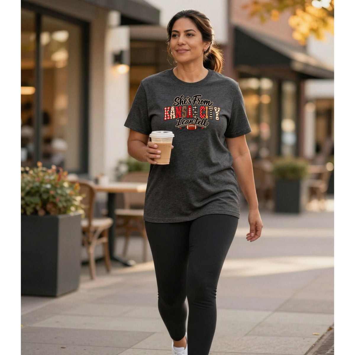 Woman in gray t-shirt with "She's From KANSAS CITY I can tell" graphic.