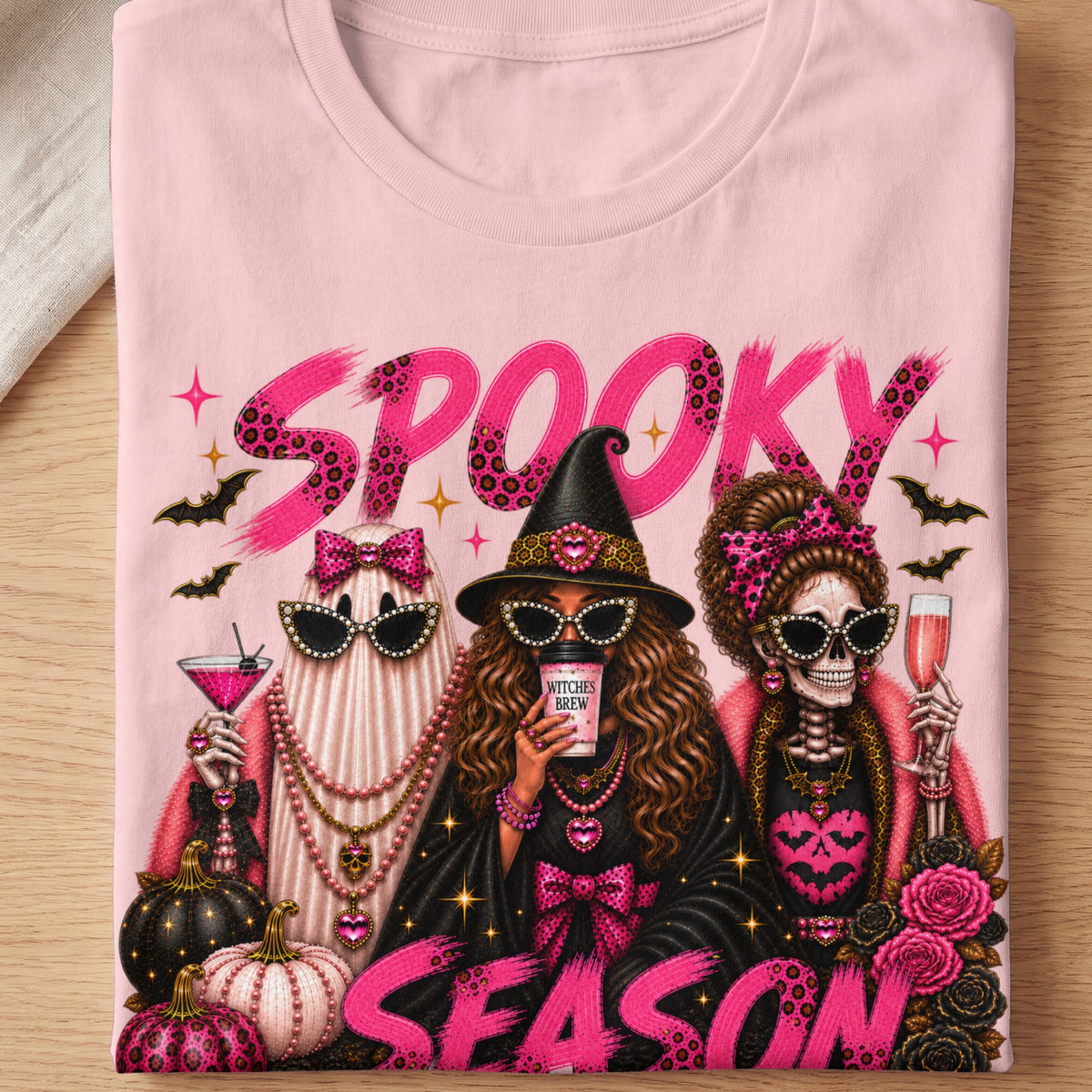 Pink t-shirt with "SPOOKY SEASON" and Halloween characters wearing sunglasses.