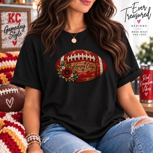 Black t-shirt with a football graphic featuring "Kansas City" and floral accents.