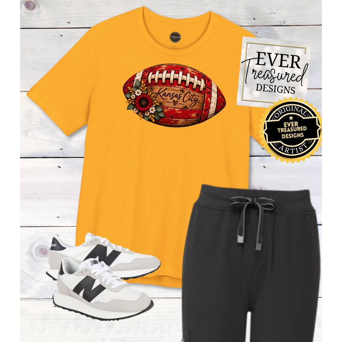 Yellow t-shirt with Kansas City football graphic, black joggers, and white sneakers.