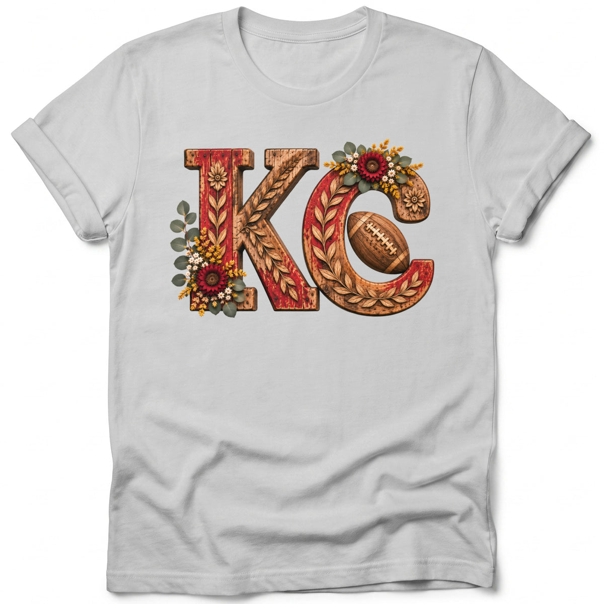 KC letters with football, flowers, and foliage on a white t-shirt.