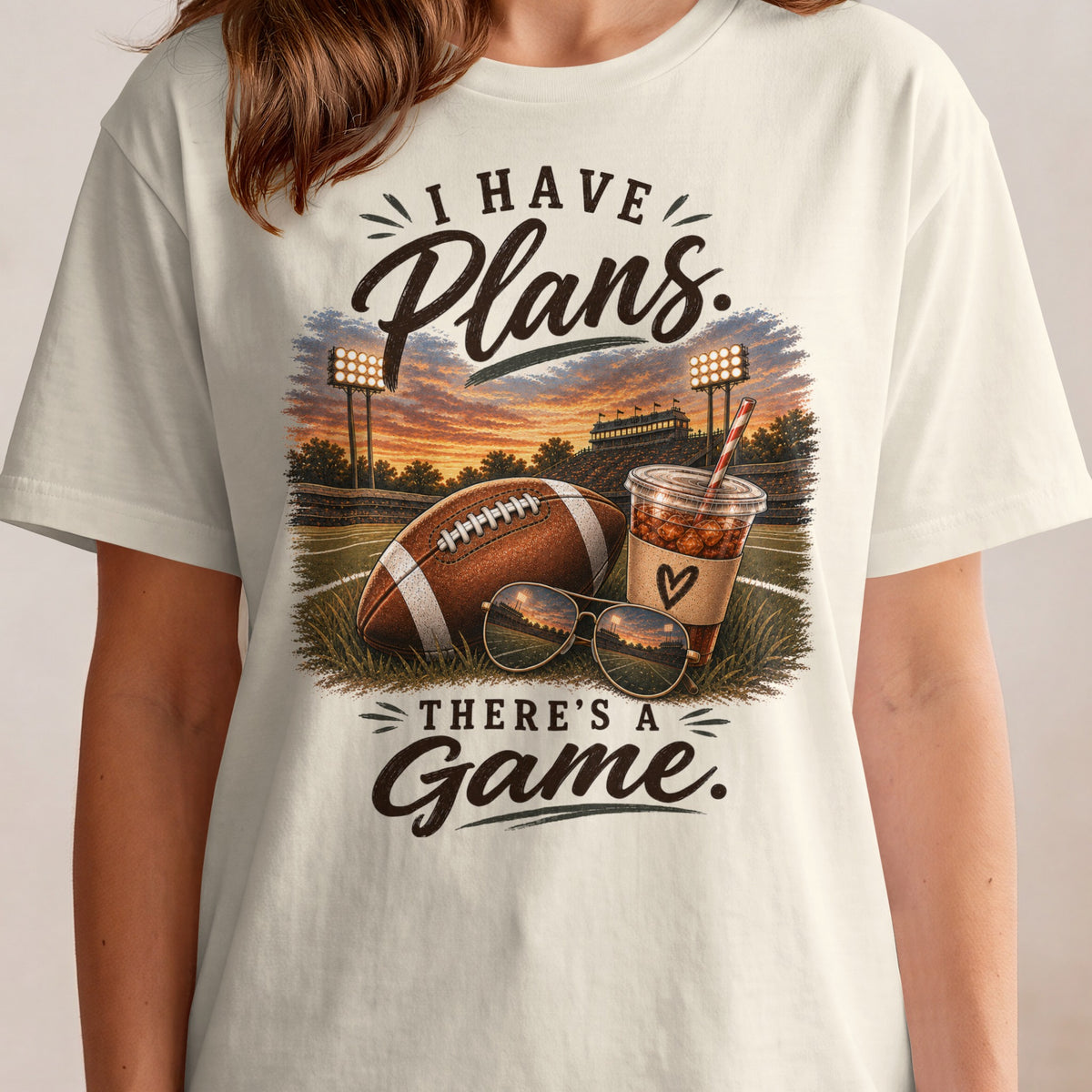I have plans, there's a game text on a shirt with football, sunglasses, and drink.