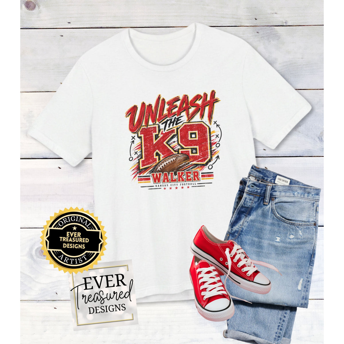 White t-shirt with "Unleash The K9 Walker Kansas City Football" graphic, jeans, and red sneakers.