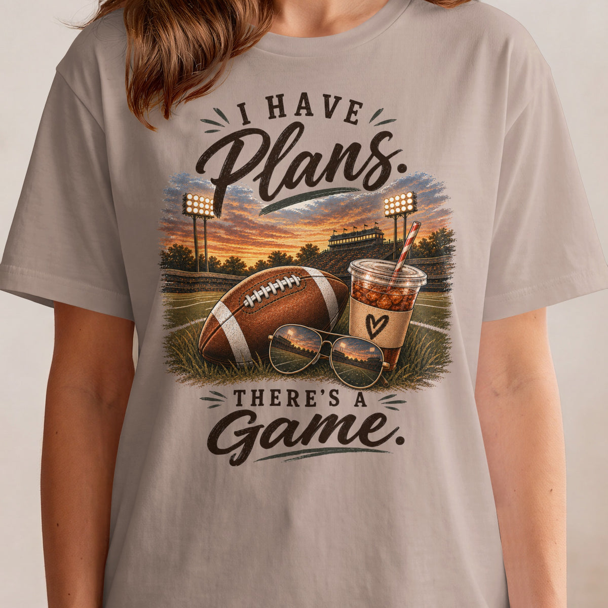 I HAVE Plans. THERE'S A Game. graphic with football and drink on stadium background.
