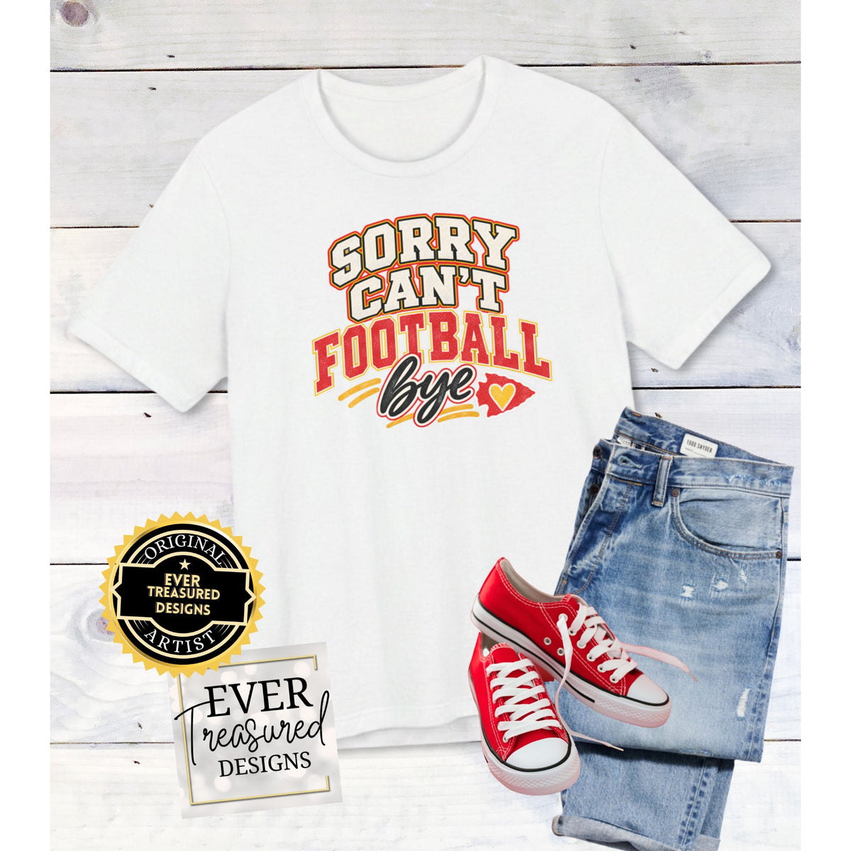 White t-shirt with "Sorry Can't Football Bye" graphic, paired with jeans and red sneakers.