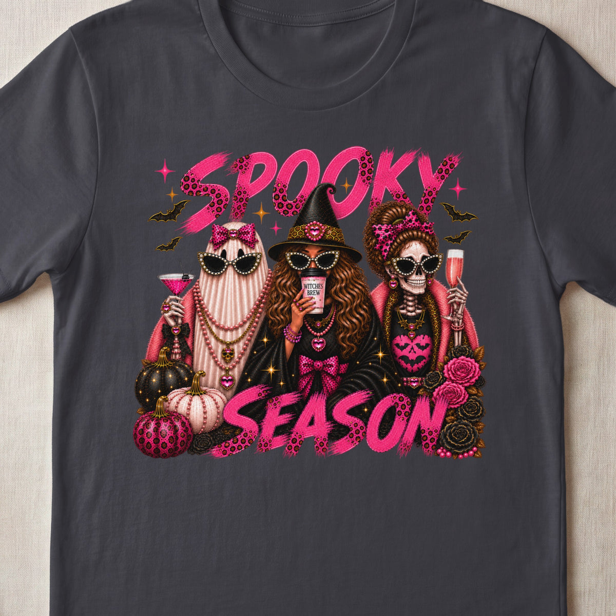Spooky Season graphic with a ghost, witch, and skeleton holding drinks among pumpkins.