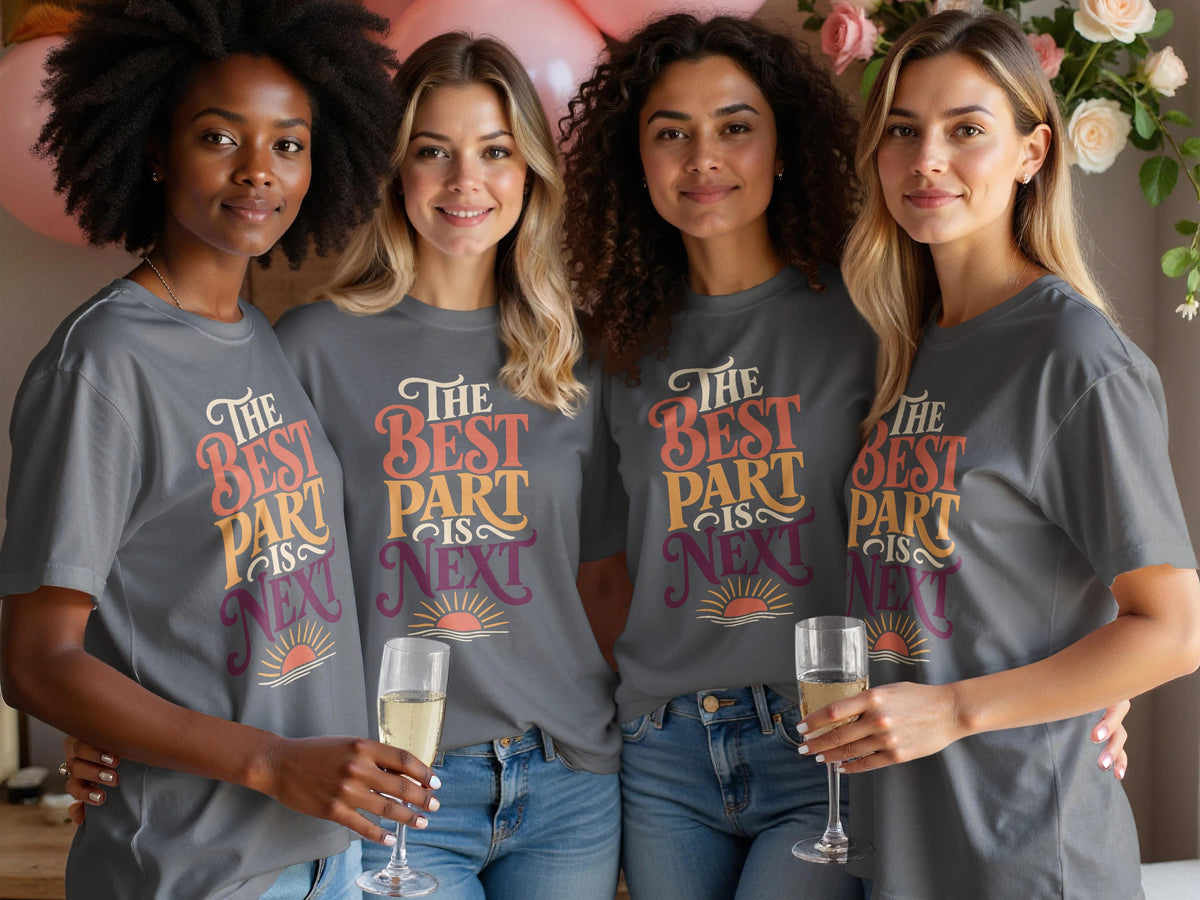 Four women in grey t-shirts with "The Best Part Is Next" text and sunset graphic.