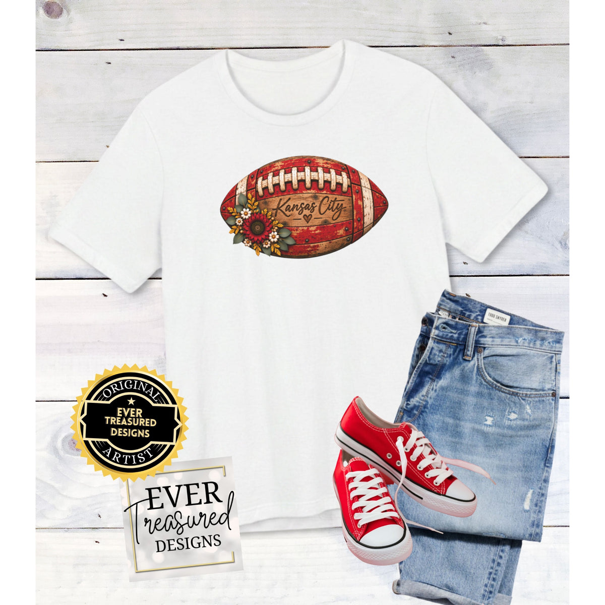 White t-shirt with Kansas City football graphic, denim jeans, and red sneakers.