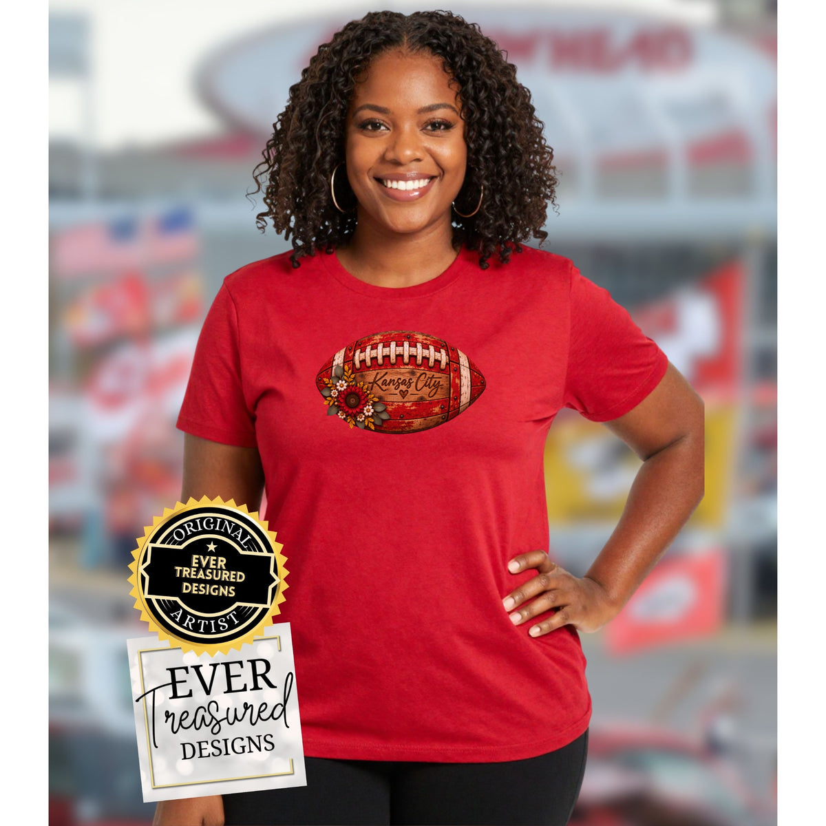 Woman in red shirt with Kansas City football graphic and floral accents.