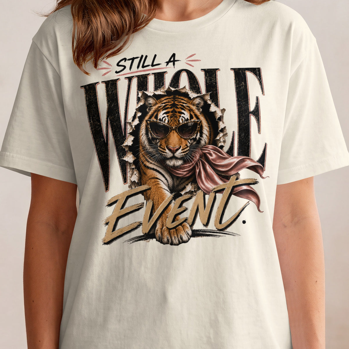 Tiger wearing sunglasses and scarf rips through shirt graphic with "Still a Whole Event" text.