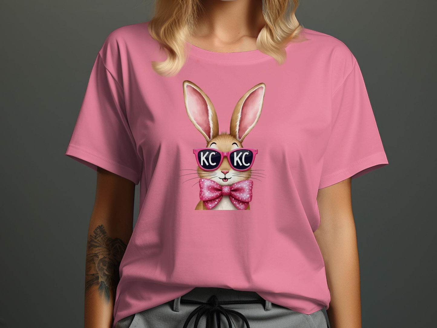 Pink t-shirt with a cartoon bunny wearing sunglasses and a bow tie.