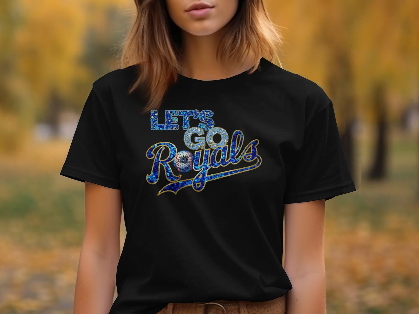 Black t-shirt with "Let's Go Royals" in glittery blue and gold lettering.