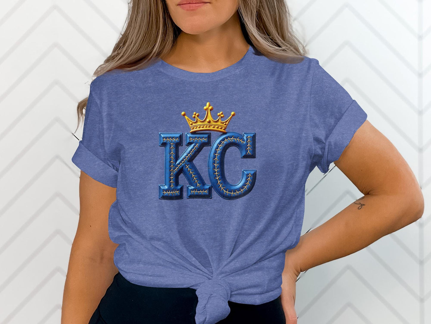 Blue t-shirt with golden crown and "KC" in bold blue letters.