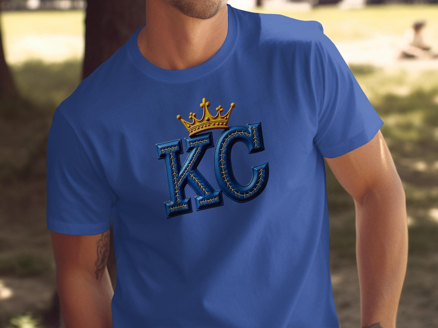 Blue t-shirt with gold crown over "KC" lettering.