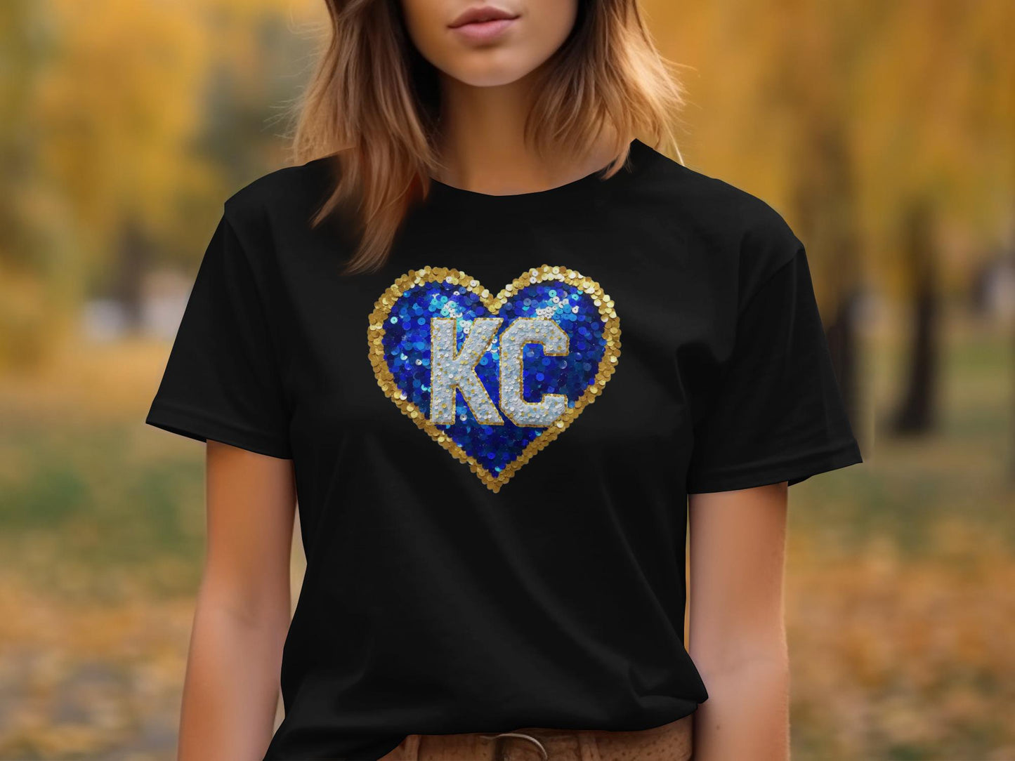 Black t-shirt with a blue and gold sequined heart featuring "KC".