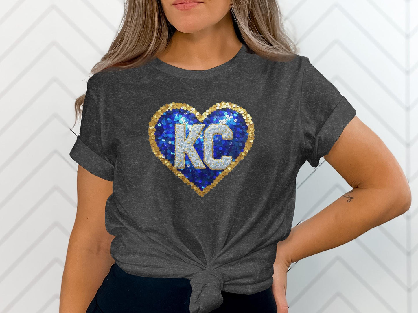 Dark grey t-shirt with a blue and gold sequined KC heart logo.