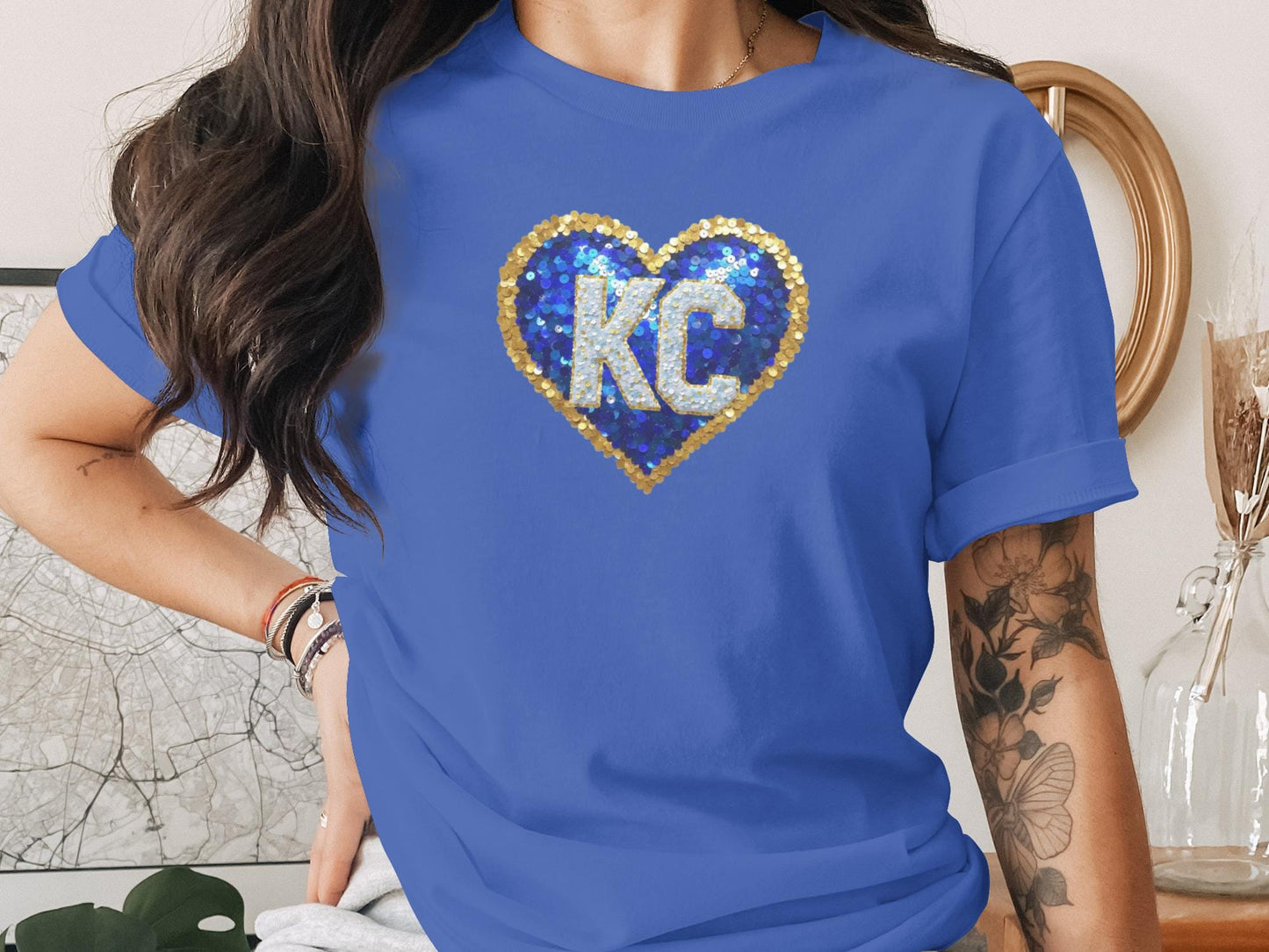 Blue t-shirt with sequined KC heart logo.