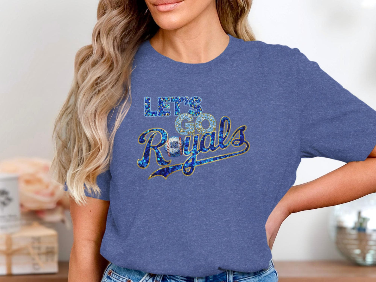 Blue t-shirt with "Let's Go Royals" in sparkling blue and gold lettering.