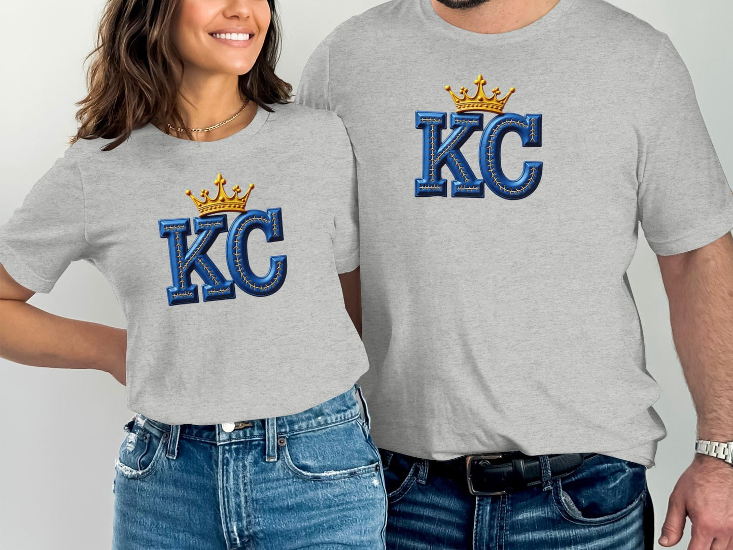 Two people wearing grey t-shirts with blue "KC" lettering and gold crowns.