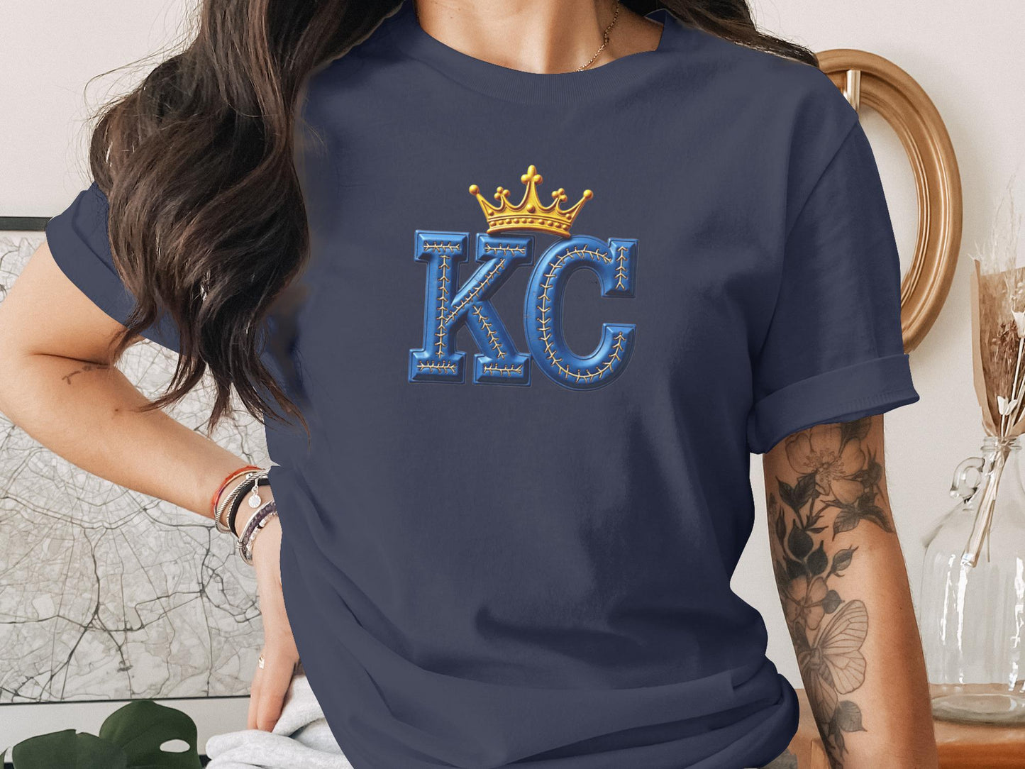 Navy t-shirt with large gold crown and "KC" text.