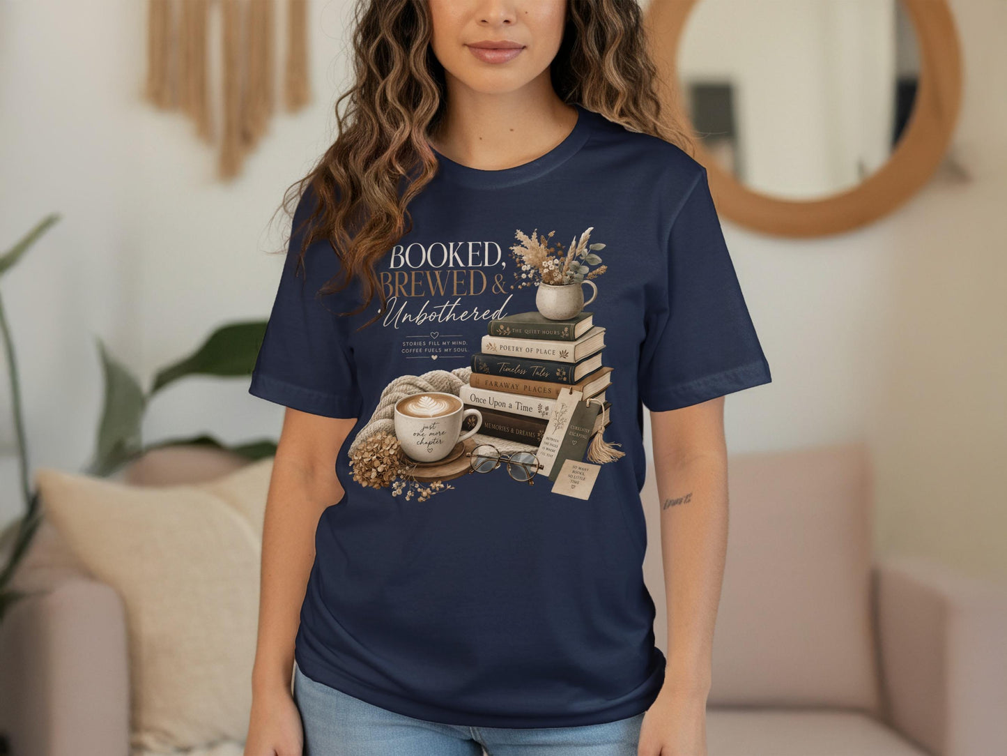 Navy t-shirt with "Booked, Brewed & Unbothered" graphic, books, coffee, and glasses.