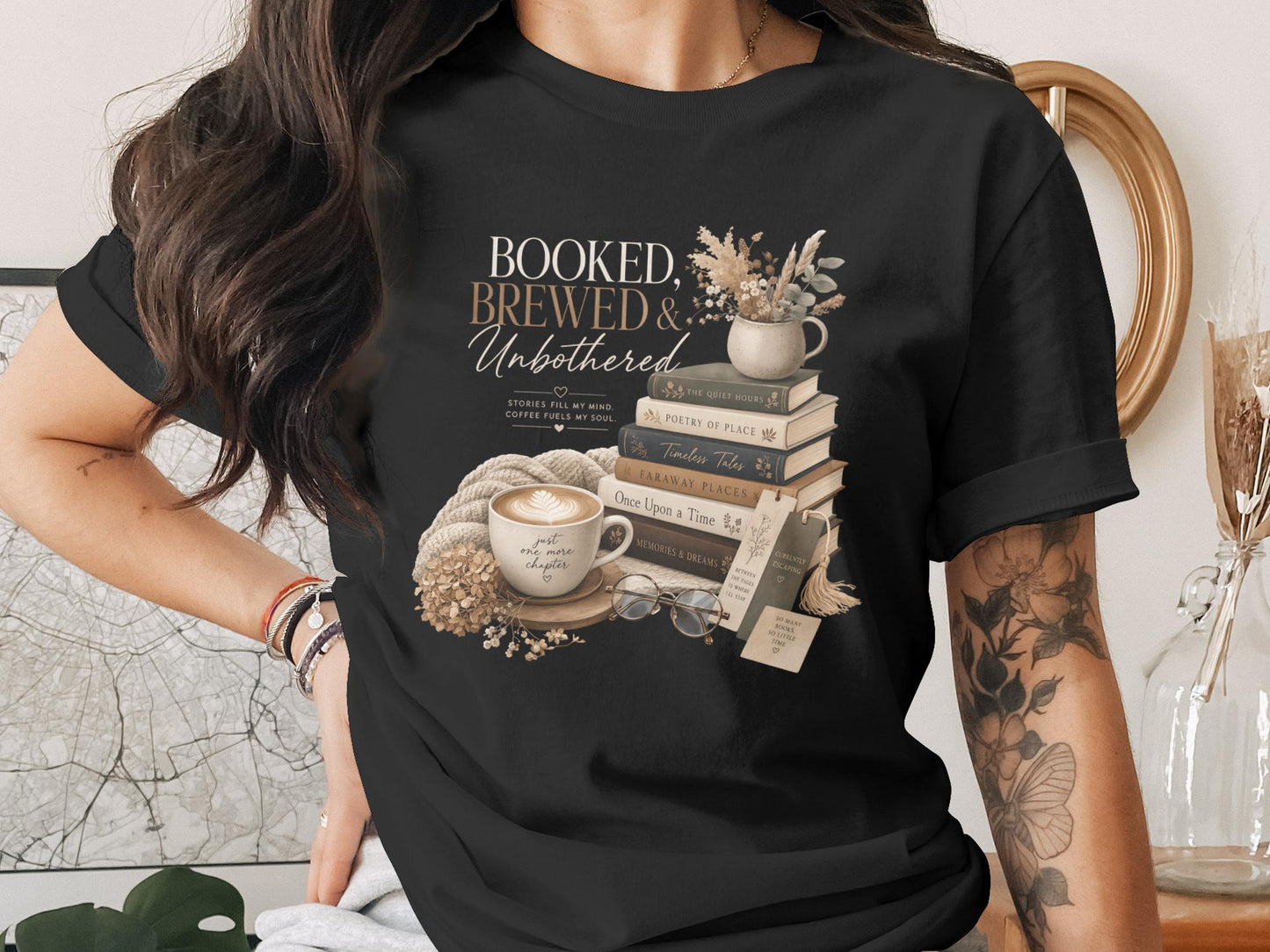 Black t-shirt with "BOOKED, BREWED & Unbothered" graphic and book stack.