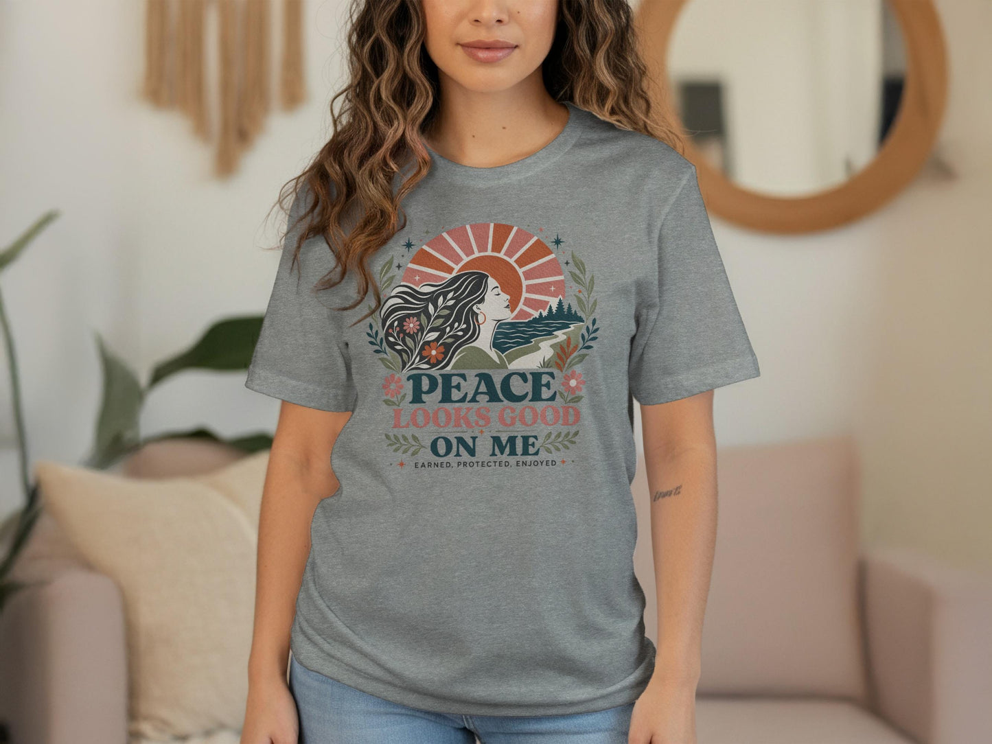 Grey t-shirt with graphic text "PEACE LOOKS GOOD ON ME" and nature design.
