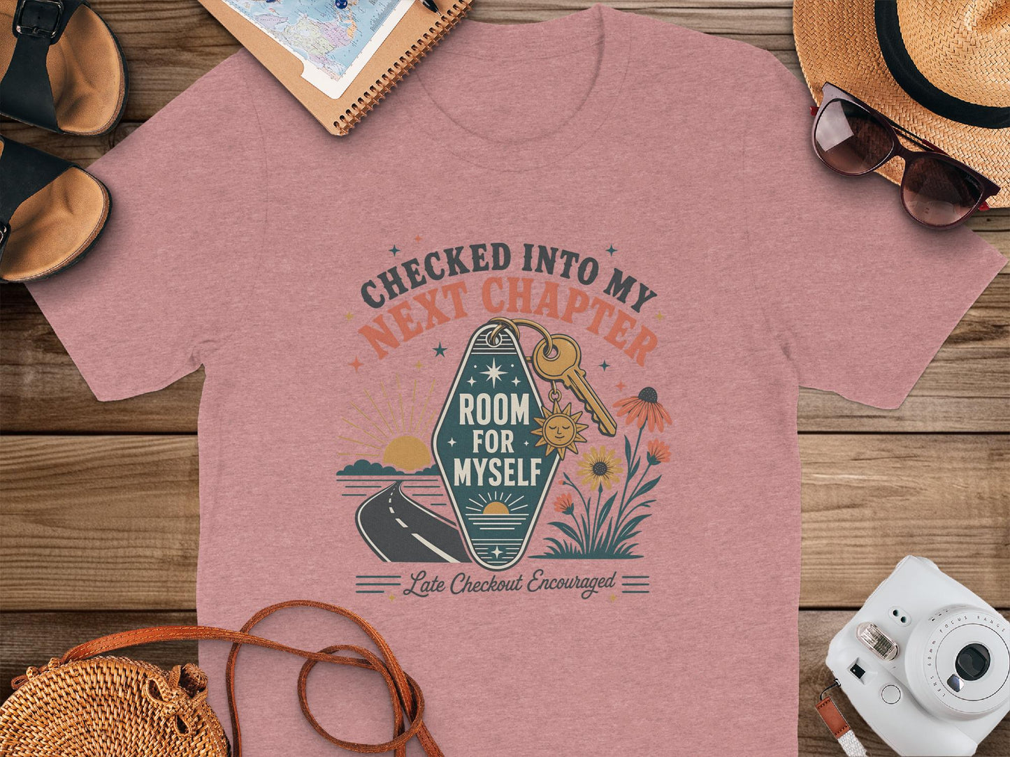 Pink t-shirt with "Checked Into My Next Chapter" and "Room for Myself" graphic.