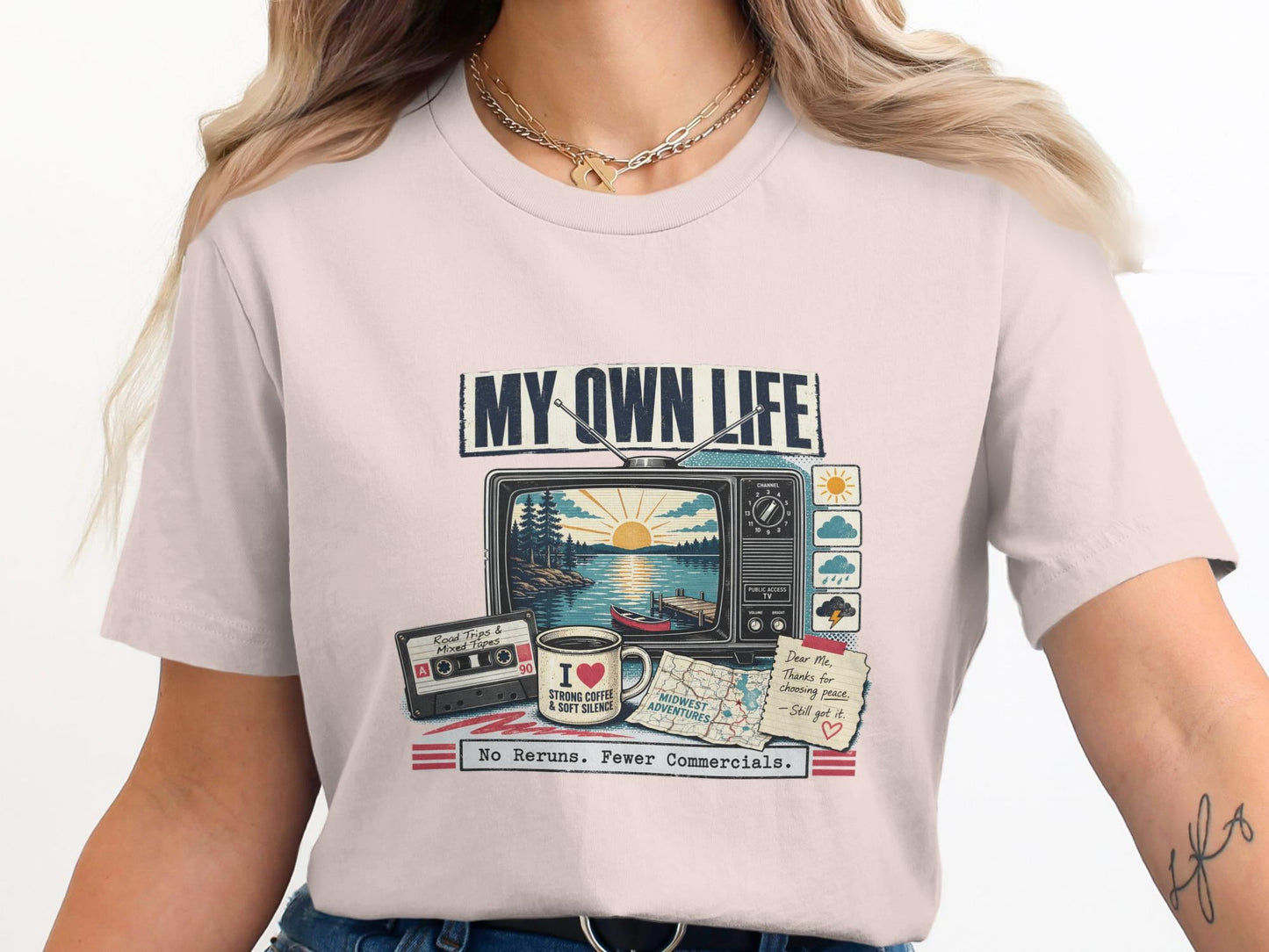 T-shirt graphic with vintage TV, cassette tape, coffee mug, and note. Text says "MY OWN LIFE" and "No Reruns. Fewer Commercials."