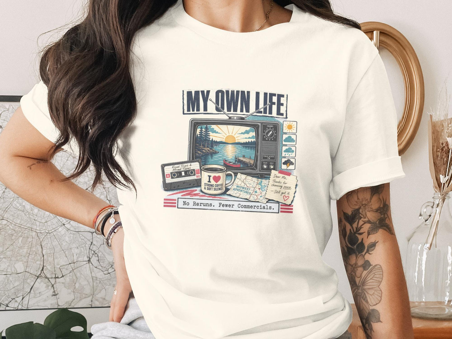 "My Own Life" graphic tee with vintage TV, cassette tape, coffee, and map designs.