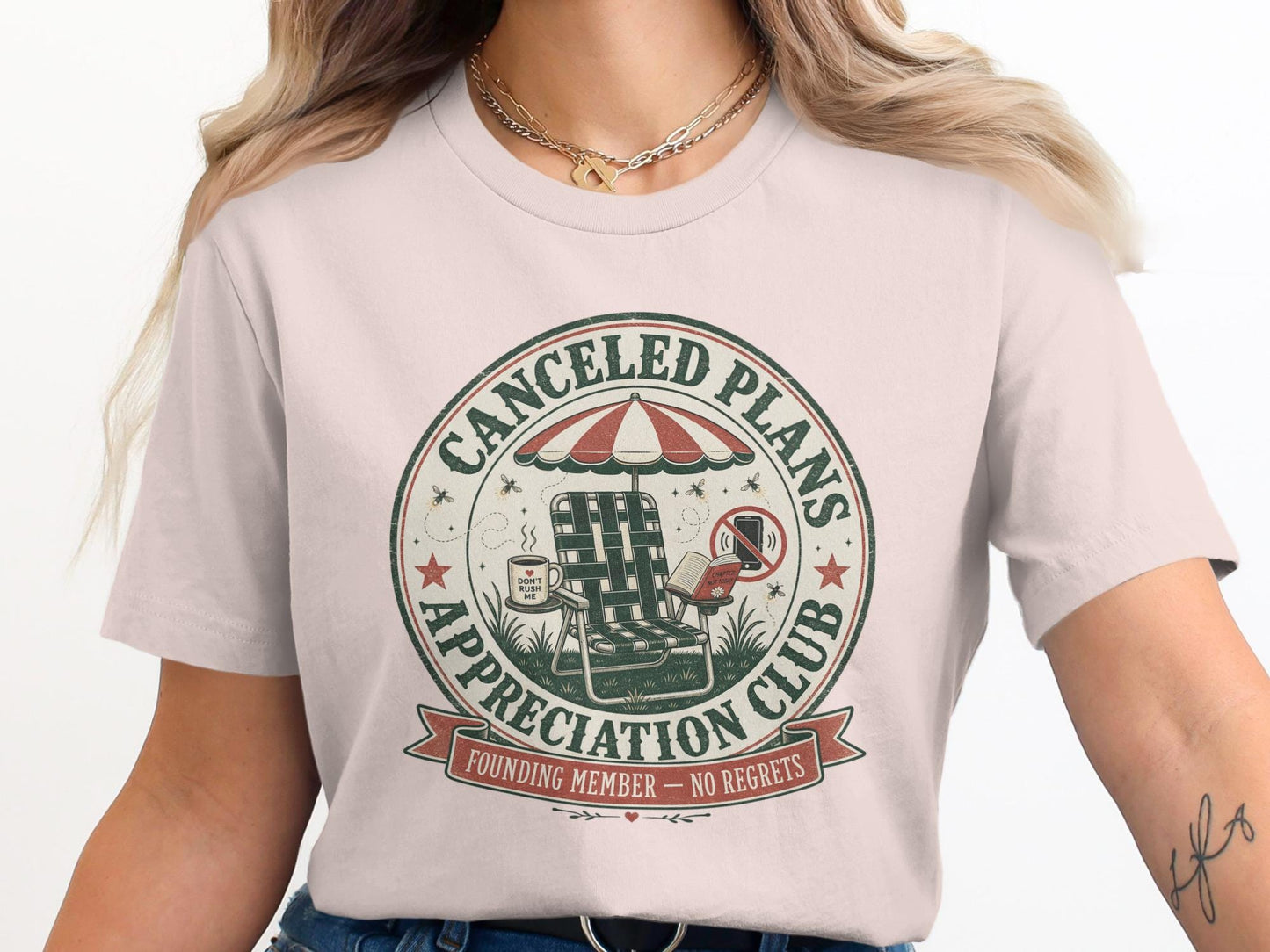 Canceled Plans Appreciation Club t-shirt with an adirondack chair, umbrella, book, and coffee.