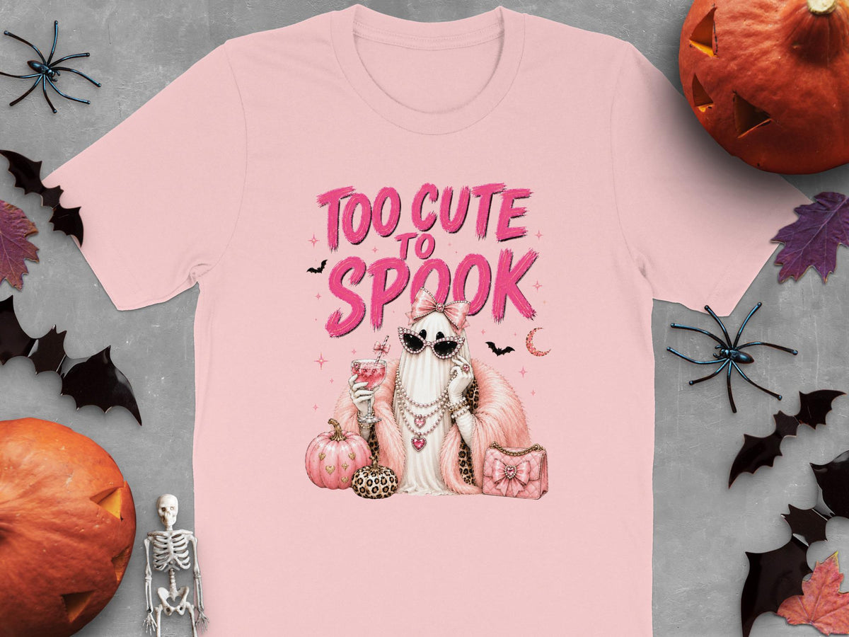 Pink t-shirt with "Too Cute to Spook" text and a glamorous ghost graphic.