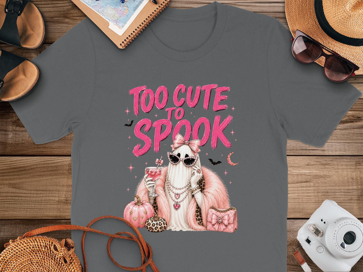 T-shirt with a ghost in sunglasses, pearls, and pink fur holding a drink, with "Too Cute to Spook" text.