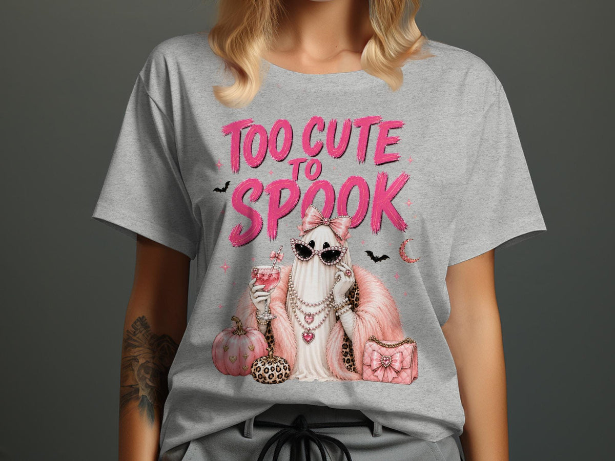 Ghost in sunglasses, pearls, and pink fur holding a drink with text "TOO CUTE TO SPOOK".