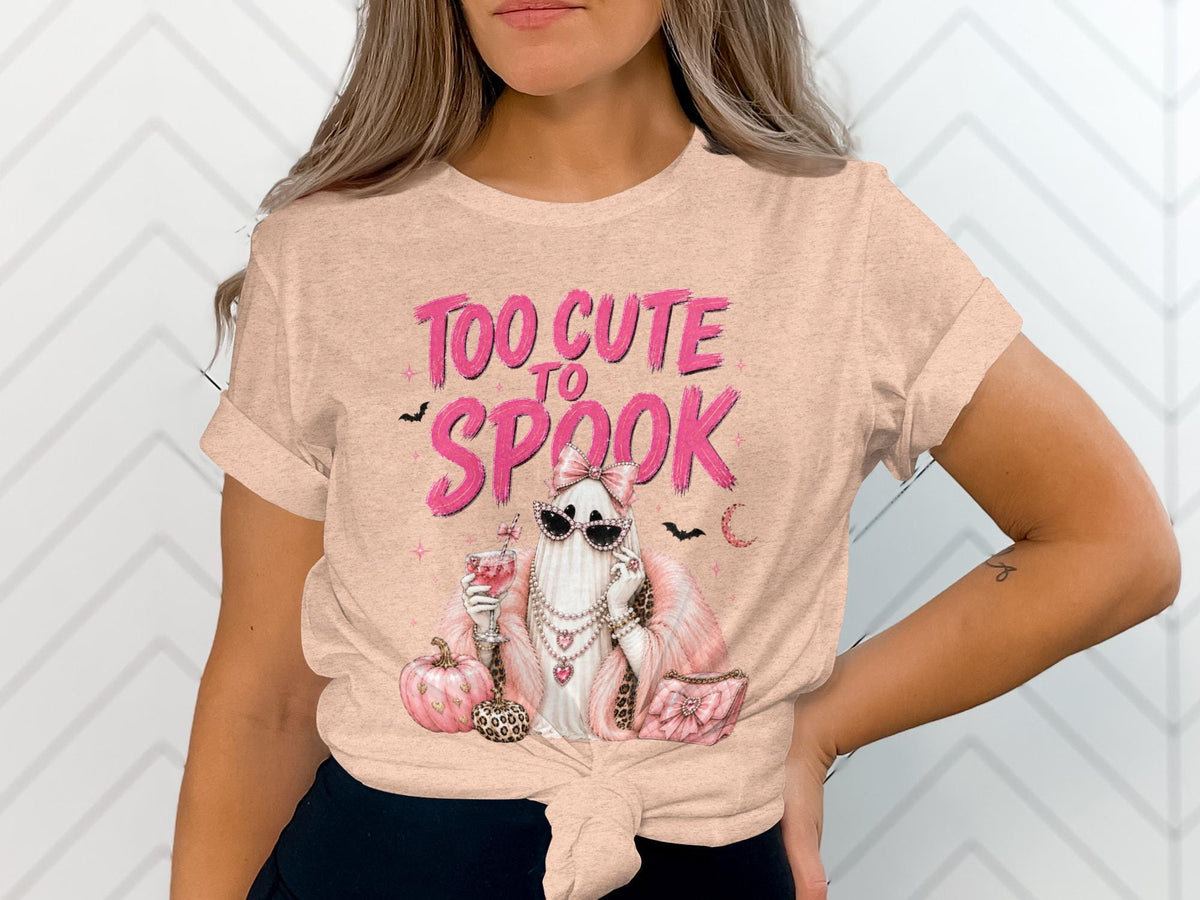 Peach t-shirt with "Too Cute to Spook" text and a glamorous ghost graphic.