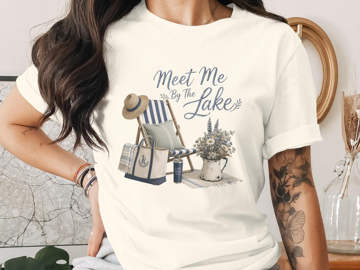 T-shirt with "Meet Me By The Lake" text and beach chair scene.