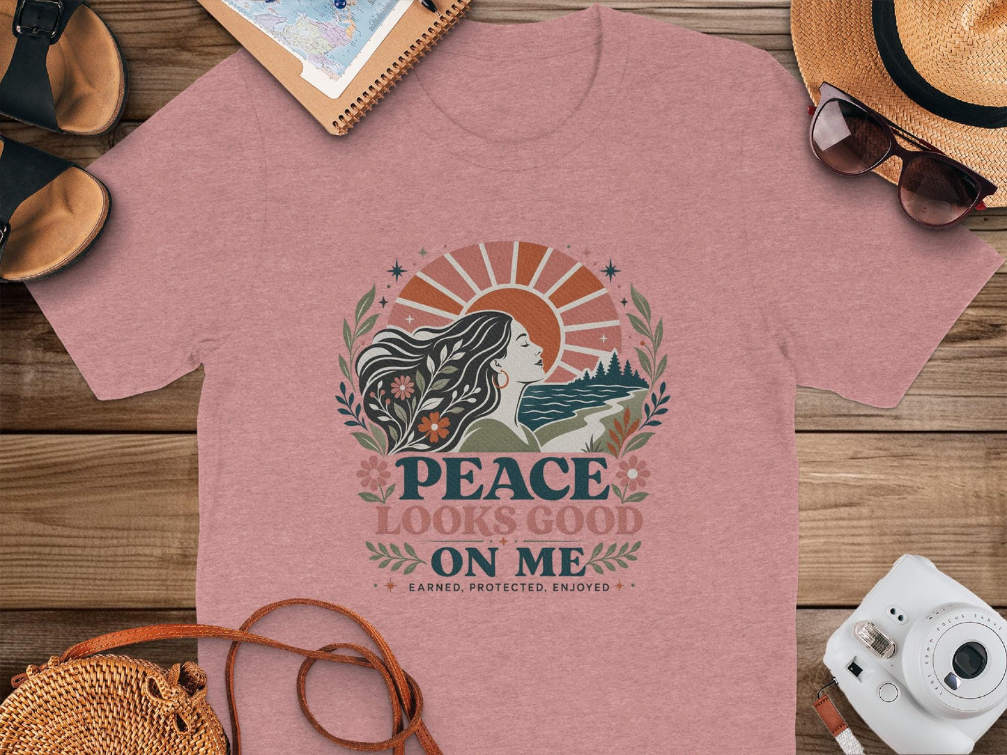 Rose t-shirt with graphic "Peace Looks Good On Me" and sun illustration.