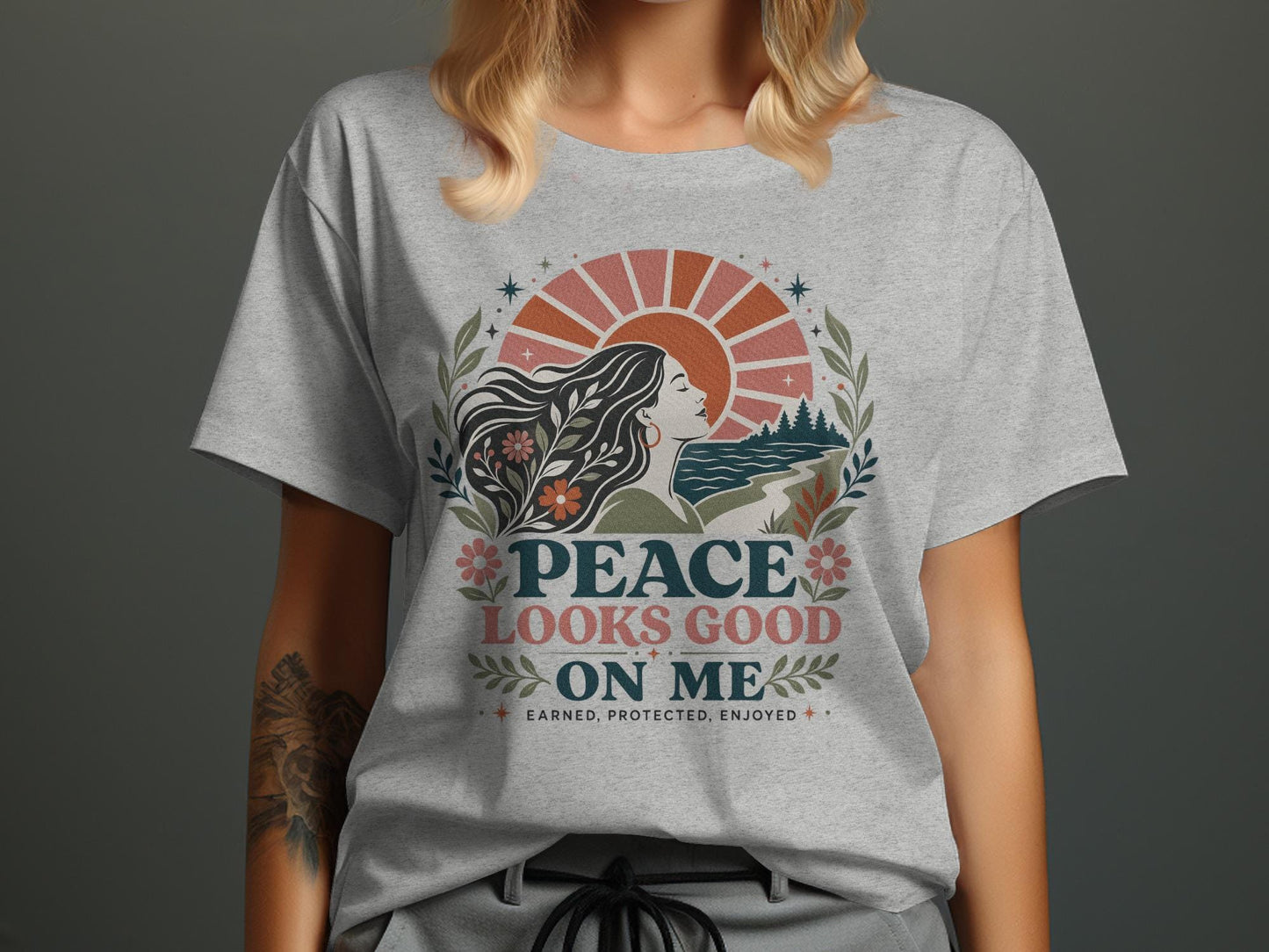 Gray t-shirt with "Peace Looks Good On Me" text and nature-inspired graphic.