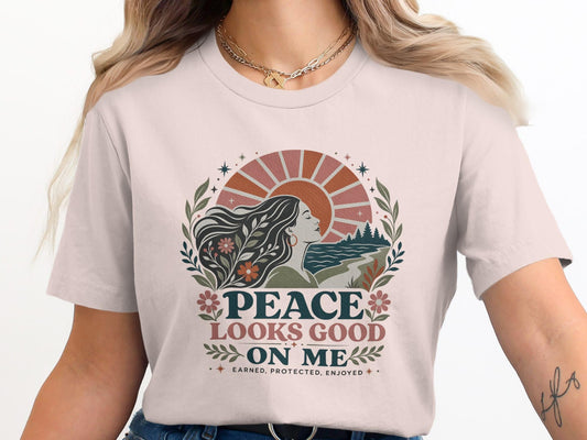 "PEACE LOOKS GOOD ON ME" text and sun design on a t-shirt.