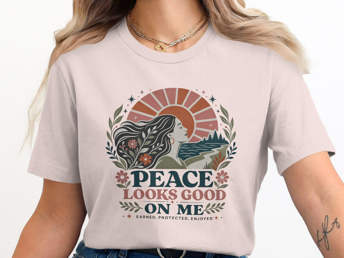 "PEACE LOOKS GOOD ON ME" text and sun design on a t-shirt.